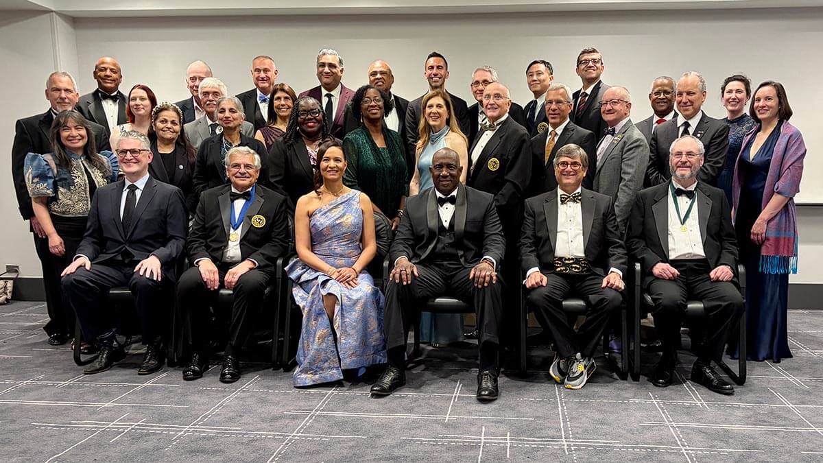 Dr. Willie Underwood III 181st President of the AMA Large group of happy adults in formal wear posing for a photo