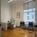 bright medical office with desk and chairs