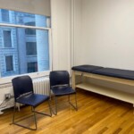 bright medical office with desk and chairs